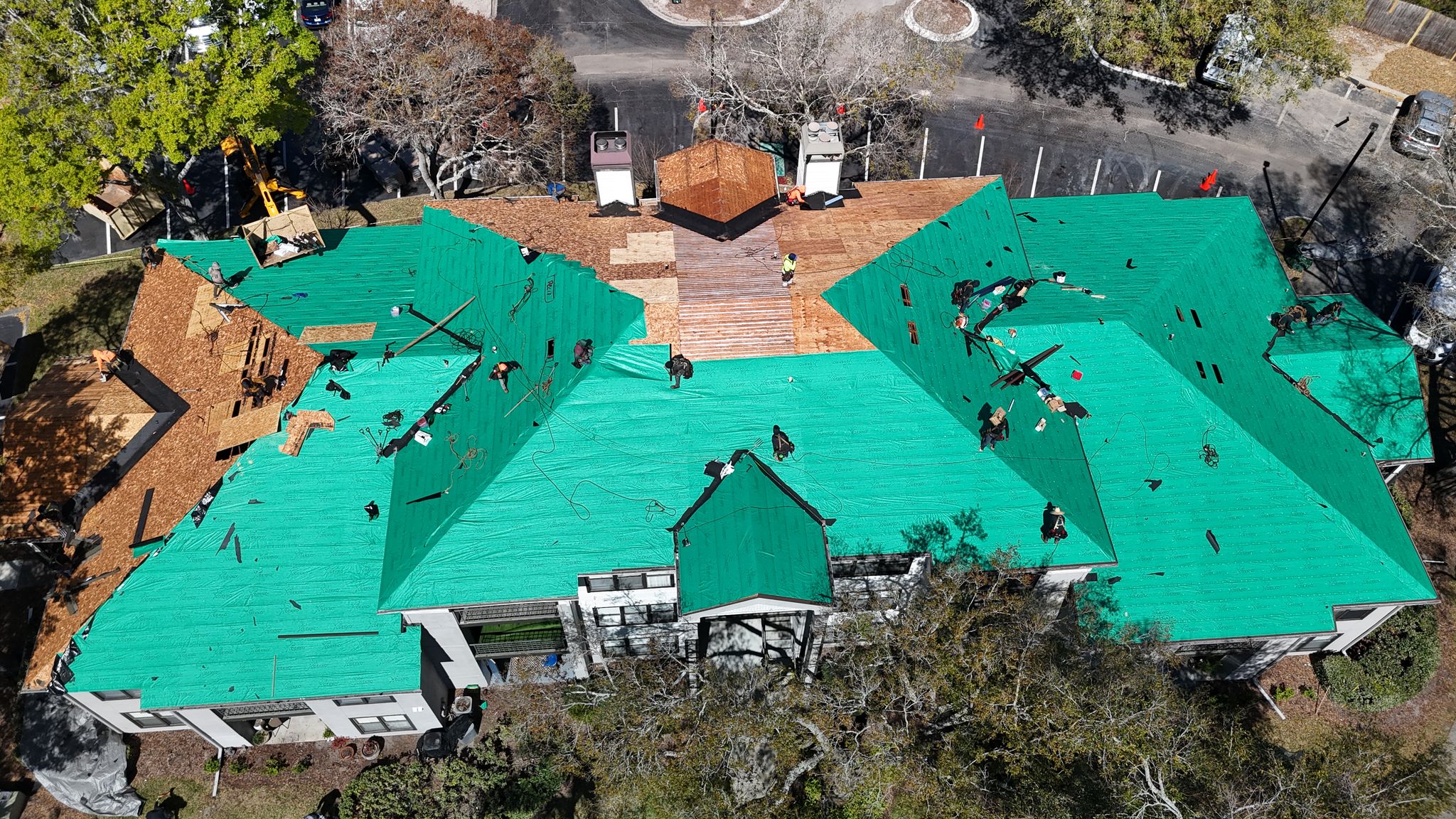 A rooftop photo of a shingle roof in progress on a commercial property