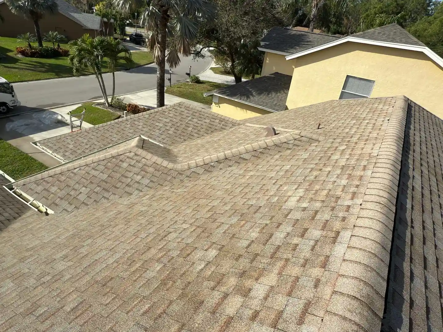 rooftop photo of a brown shingle roof