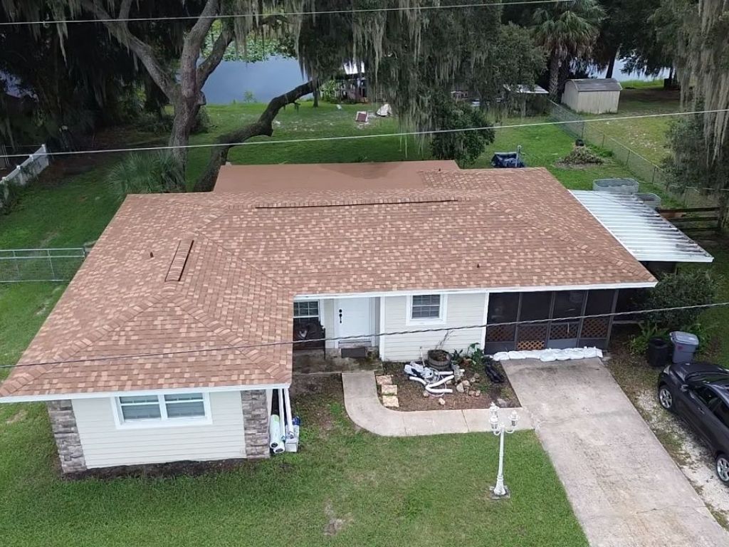 Aerial view of a residential Florida home with asphalt shingle roof after roof repair or inspection.