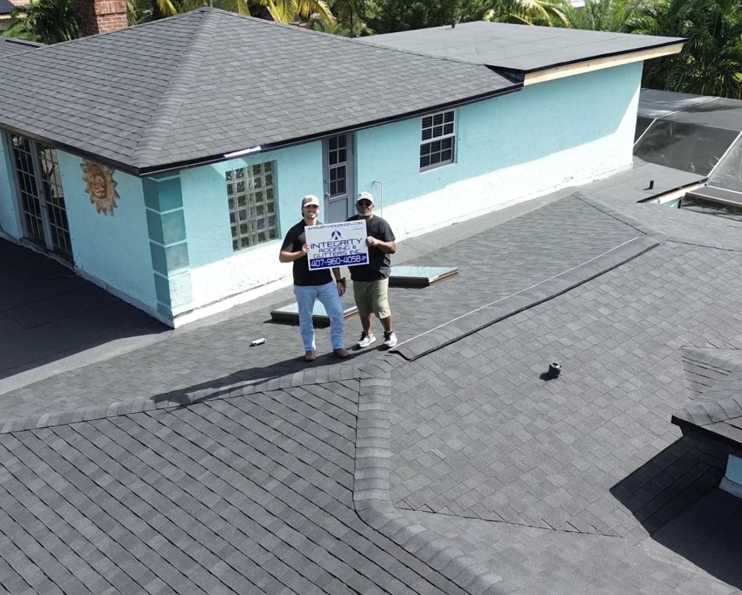 Integrity roofing team replacing a roof of commercial home.