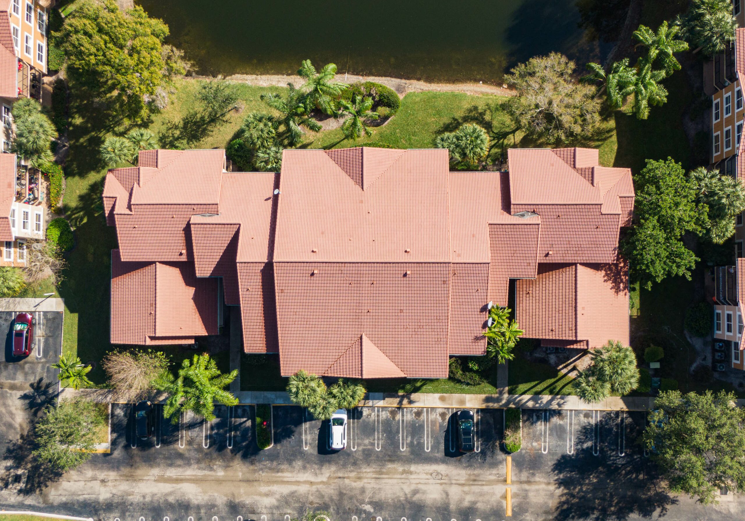 Aerial view of an apartment building with a tile roof