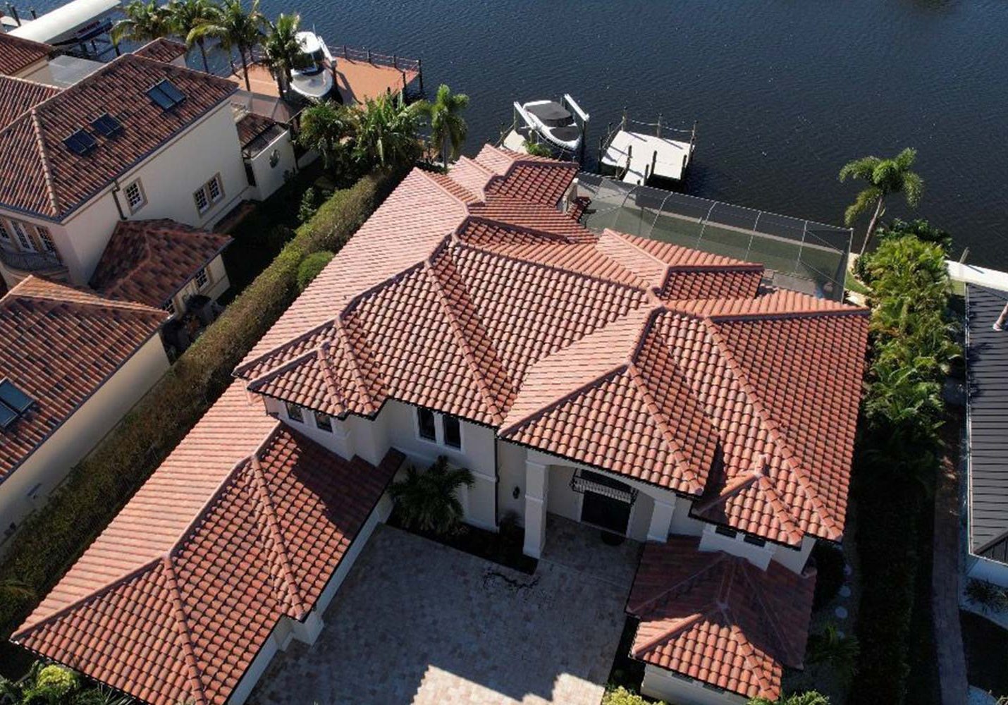 Curved reddish clay roof tiles with visible texture and slope